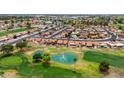 A beautiful aerial view of a community golf course with scenic landscaping, and blue skies at 2461 Leisure World --, Mesa, AZ 85206