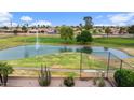 Scenic view of a golf course featuring a water hazard with a fountain and a clear blue sky at 2461 Leisure World --, Mesa, AZ 85206