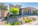 Lovely single-Gathering house with manicured desert landscaping and a modern gray garage door at 2885 N 164Th Dr, Goodyear, AZ 85395