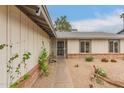 Charming single-story home with drought-resistant landscaping, a security gate, and a quaint walkway to the entrance at 3215 W Phelps Rd, Phoenix, AZ 85053