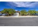 Street view featuring several single-story homes with desert landscaping, and attached two-car garages at 33974 N Beeblossom Trl, San Tan Valley, AZ 85144