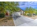 Well-maintained single-story home showcasing desert landscaping, a two-car garage, and an inviting entrance at 33974 N Beeblossom Trl, San Tan Valley, AZ 85144