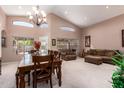 Bright living room with vaulted ceilings, large windows, and elegant chandelier providing an airy atmosphere at 462 S Marie Dr, Chandler, AZ 85225