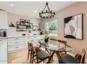Elegant dining area with a glass table, stylish chandelier, and contemporary decor at 5605 N 19Th St, Phoenix, AZ 85016
