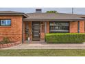 Close-up of front door and manicured landscaping enhance this brick home's curb appeal at 5605 N 19Th St, Phoenix, AZ 85016
