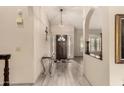 Entryway with tiled floors, light fixture, and an arched entryway at 6019 E Paradise Ln, Scottsdale, AZ 85254