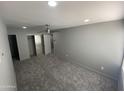 Spacious bedroom features plush gray carpet, recessed lighting, fan, and closet at 6041 W Golden Ln, Glendale, AZ 85302