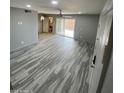Open living room with contemporary floors, neutral walls, sliding glass doors, and ceiling fan at 6041 W Golden Ln, Glendale, AZ 85302