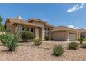Well-maintained front yard with desert landscaping and beautiful curb appeal at 6528 W Via Montoya Dr, Glendale, AZ 85310