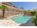 Sparkling backyard pool with stone patio and a privacy wall at 6528 W Via Montoya Dr, Glendale, AZ 85310