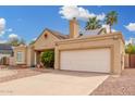 Home exterior with two-car garage, neutral stucco, well-kept yard, and ample driveway parking at 7229 S Butte Ave, Tempe, AZ 85283