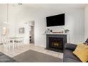 Comfortable living room featuring a fireplace, tile floors, neutral walls, and a view to the dining area at 7229 S Butte Ave, Tempe, AZ 85283
