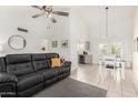 Open-concept living room with tile floors, vaulted ceiling, and view into the dining area and kitchen at 7229 S Butte Ave, Tempe, AZ 85283