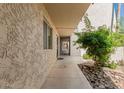 View of the exterior of the condo showing a walkway and manicured landscaping at 7625 E Camelback Rd # B124, Scottsdale, AZ 85251