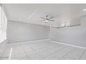Bright and open living area with tile flooring and modern ceiling fans at 7720 W Indianola Ave, Phoenix, AZ 85033