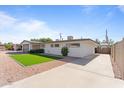 Single-story home featuring low maintenance landscaping, long driveway, and a bright white exterior at 8044 N 10Th Pl, Phoenix, AZ 85020