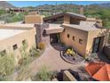 Attractive desert home featuring a stone accent wall and decorative desert landscaping at 9998 E Taos Dr, Scottsdale, AZ 85262