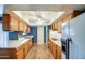 Well-lit kitchen with abundant cabinet space, a double sink, and modern appliances for easy meal prep at 10435 W Roundelay Cir, Sun City, AZ 85351