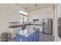 Beautiful kitchen with stainless steel appliances, white cabinets, and a central island at 20718 N 58Th Dr, Glendale, AZ 85308