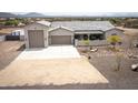 Aerial view of home showcasing driveway, xeriscaping and large three-car garage at 34047 N 10Th St, Phoenix, AZ 85085