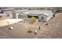 Aerial view showcasing home with a well-maintained front yard, xeriscaping, and a boat parked to the side at 34047 N 10Th St, Phoenix, AZ 85085