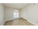 Cozy bedroom with a built-in bookshelf, a shuttered window and vinyl floors at 3774 W Wood Dr, Phoenix, AZ 85029