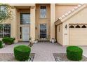 Inviting home entrance with paved walkway, manicured shrubs, and seating area at 4106 E Lavender Ln, Phoenix, AZ 85044