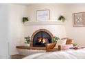 Close-up of a cozy fireplace with charming details and decorative accents, creating a warm ambiance at 5001 E Redfield Rd, Scottsdale, AZ 85254