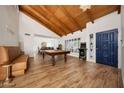 Inviting living room featuring wood-look flooring, a wood ceiling, and arcade games for added entertainment at 5001 E Redfield Rd, Scottsdale, AZ 85254
