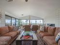 Spacious living room with plush sofas, fireplace, and large windows boasting scenic views at 5412 E Rockridge Rd, Phoenix, AZ 85018