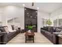 Bright living room offering modern furniture, sleek fireplace feature, and ample seating at 6217 W Comet Ave, Glendale, AZ 85302