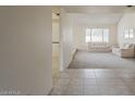 Bright living room featuring neutral carpet, white walls, and large windows at 14221 N 45Th St, Phoenix, AZ 85032
