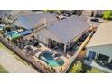 Aerial view of a backyard with a pool, patio, and outdoor kitchen, ideal for entertaining and relaxation at 1437 E Glenhaven Dr, Phoenix, AZ 85048