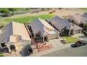Aerial view of a well-maintained community with lush green spaces, showcasing the neighborhood's layout at 1437 E Glenhaven Dr, Phoenix, AZ 85048