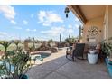 Relaxing backyard patio area with comfortable seating and a view of the inviting pool and spa at 1437 E Glenhaven Dr, Phoenix, AZ 85048