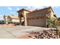 Charming home exterior showcasing a well-maintained lawn, rock landscaping, and a spacious three-car garage at 1437 E Glenhaven Dr, Phoenix, AZ 85048