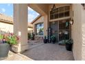 Inviting front entrance featuring a decorative security door, potted plants, and a welcoming ambiance at 1437 E Glenhaven Dr, Phoenix, AZ 85048