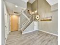 Bright entryway with gray wood-look tile, pendant lighting, and contemporary staircase at 16 W Encanto Blvd # 22, Phoenix, AZ 85003