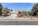 Beautiful home with a white exterior, tile roof, landscaped yard, and a two-car garage with a white door at 1978 E Carver Rd, Tempe, AZ 85284