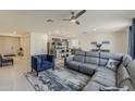 Stylish living room featuring tile flooring, a plush sofa, and modern decor at 2775 N Mulberry Pl, Casa Grande, AZ 85122