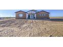 Beautiful home with earth tone exterior and minimalist desert landscaping at 3033 N 367Th Ave, Tonopah, AZ 85354
