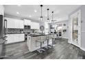 Modern kitchen features a center island with counter seating and an open dining area at 3713 W Abrams Dr, New River, AZ 85087
