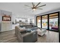 Bright living room featuring wood-look floors, modern furnishings, and backyard views at 3713 W Abrams Dr, New River, AZ 85087
