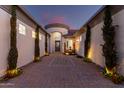 Inviting front entrance featuring a serene water feature, brick-paved driveway, and beautiful landscaping at 3931 E Fox Cir, Mesa, AZ 85205