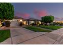 Charming single-story home featuring a three-car garage, manicured landscaping, and spacious driveway at 3931 E Fox Cir, Mesa, AZ 85205