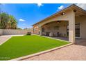 Beautiful backyard features a covered patio and well-manicured artificial grass at 4119 E Tether Trl, Phoenix, AZ 85050