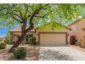 Charming single-story home features a desert landscape and a two-car garage at 4119 E Tether Trl, Phoenix, AZ 85050