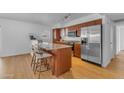 Bright kitchen with stainless steel appliances, kitchen island, and wood cabinets at 5315 S River Dr, Tempe, AZ 85283
