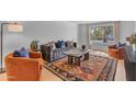Bright living room boasts a comfortable sofa, large window, and hardwood floors at 5315 S River Dr, Tempe, AZ 85283