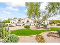 Stunning home exterior featuring lush desert landscaping, a circular driveway, and a gated entrance at 7003 E Avenida El Alba --, Paradise Valley, AZ 85253